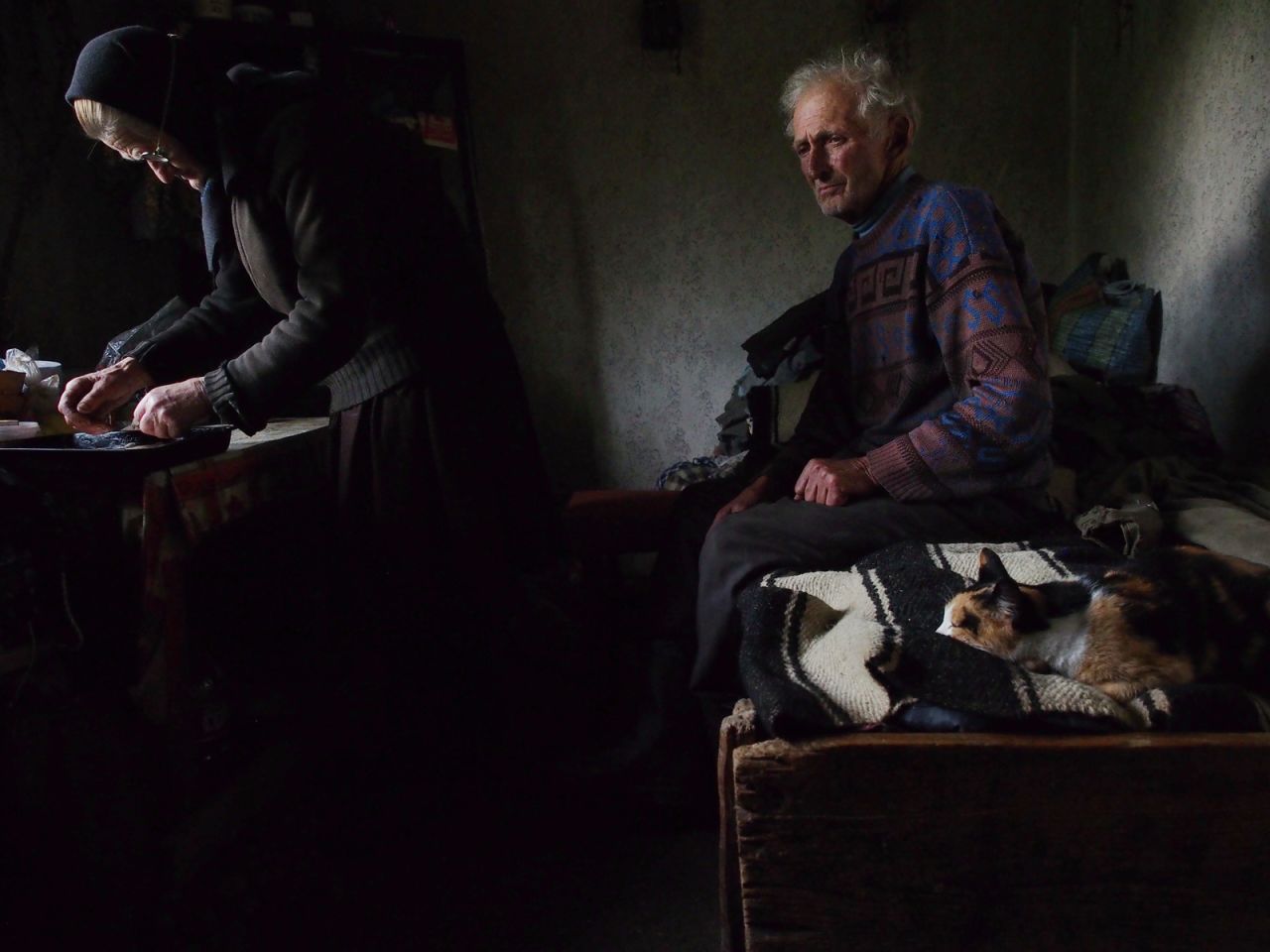 <strong>Honorable Mention People: "Waiting"</strong><br /><br />Location: Village of Sarbi, Maramure (Romania) <br /><br />Photo and caption by <a href="http://photography.nationalgeographic.com/photography/photo-contest/2014/users/2856841/" target="_blank" target="_blank">Roberto Fiore</a>/National Geographic 2014 Photo Contest<br /><br />Roberto Fiore says: "He was waiting on the bed, lost in thoughts, while his wife was preparing the bread to be blessed for the orthodox Eucharist."