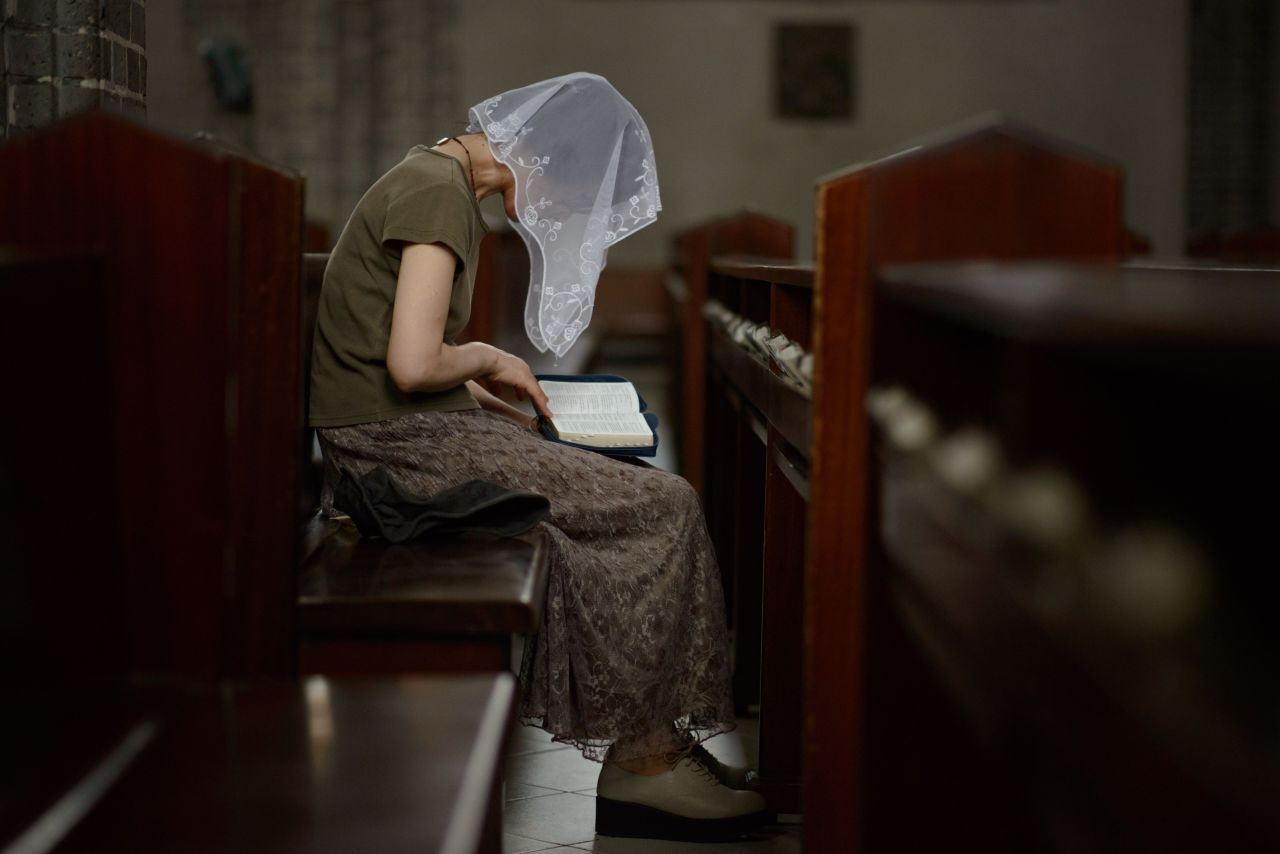 A Catholic worshiper reads from a Bible at the Myeong-dong Cathedral in Seoul on August 6, 2014. Although North Korea has some state-controlled churches, the regime forbids independent religious activities.