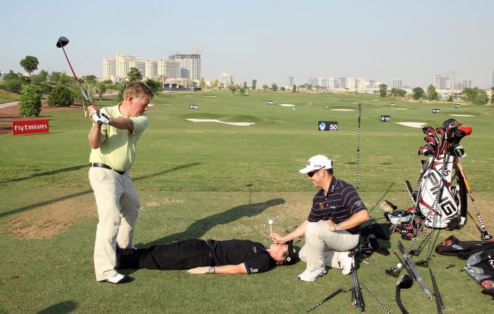 He might have won four majors, but Rory McIlroy is also brave enough to go where few other golfers have gone before. The Northern Irishman (center) was game when trick shot artist David Edwards (left) needed a volunteer.   