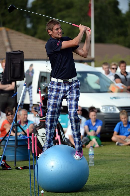 Don't try this at home ... Here Briton Kevin Carpenter uses a Swiss ball during his trick shot show at the Ian Poulter Invitational event at Woburn Golf Club in July 2013.