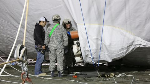 Crew check the inflation of the Army aerostat.