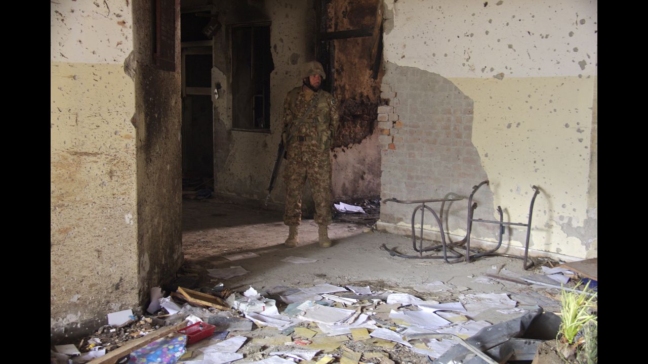 A soldier walks outside the Pakistani school <a href="http://www.cnn.com/2014/12/16/asia/gallery/taliban-attack-peshawar-school/index.html">that was attacked</a> by members of the Pakistani Taliban on Tuesday, December 16. CNN cameraman Javed Iqbal took these photos in the aftermath of the attack, which killed more than 140 people.