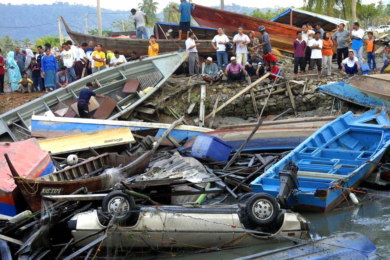 Fishing boats and a car are among the debris left along the coast of Langkawi in northwest Malaysia on December 26, 2004. 