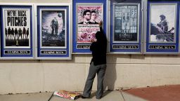 A poster for the movie "The Interview" is taken down by a worker after being pulled from a display case at a Carmike Cinemas movie theater, Wednesday, Dec. 17, 2014, in Atlanta. Georgia-based Carmike Cinemas has decided to cancel its planned showings of "The Interview" in the wake of threats against theatergoers by the Sony hackers.
