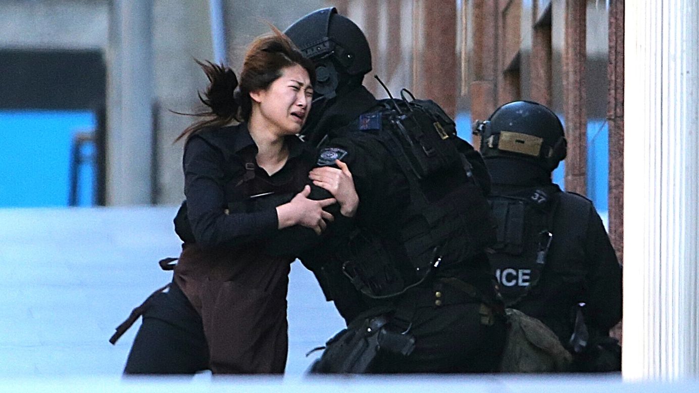 A woman runs to police officers after she escaped <a href="http://www.cnn.com/2014/12/14/world/gallery/sydney-police-operation/index.html" target="_blank">a hostage situation at a Sydney cafe</a> on Monday, December 15. The siege ended with the death of the gunman and two of his hostages, but <a href="http://www.cnn.com/2014/12/16/world/asia/australia-sydney-cafe-siege-questions/index.html" target="_blank">questions remain unanswered.</a>