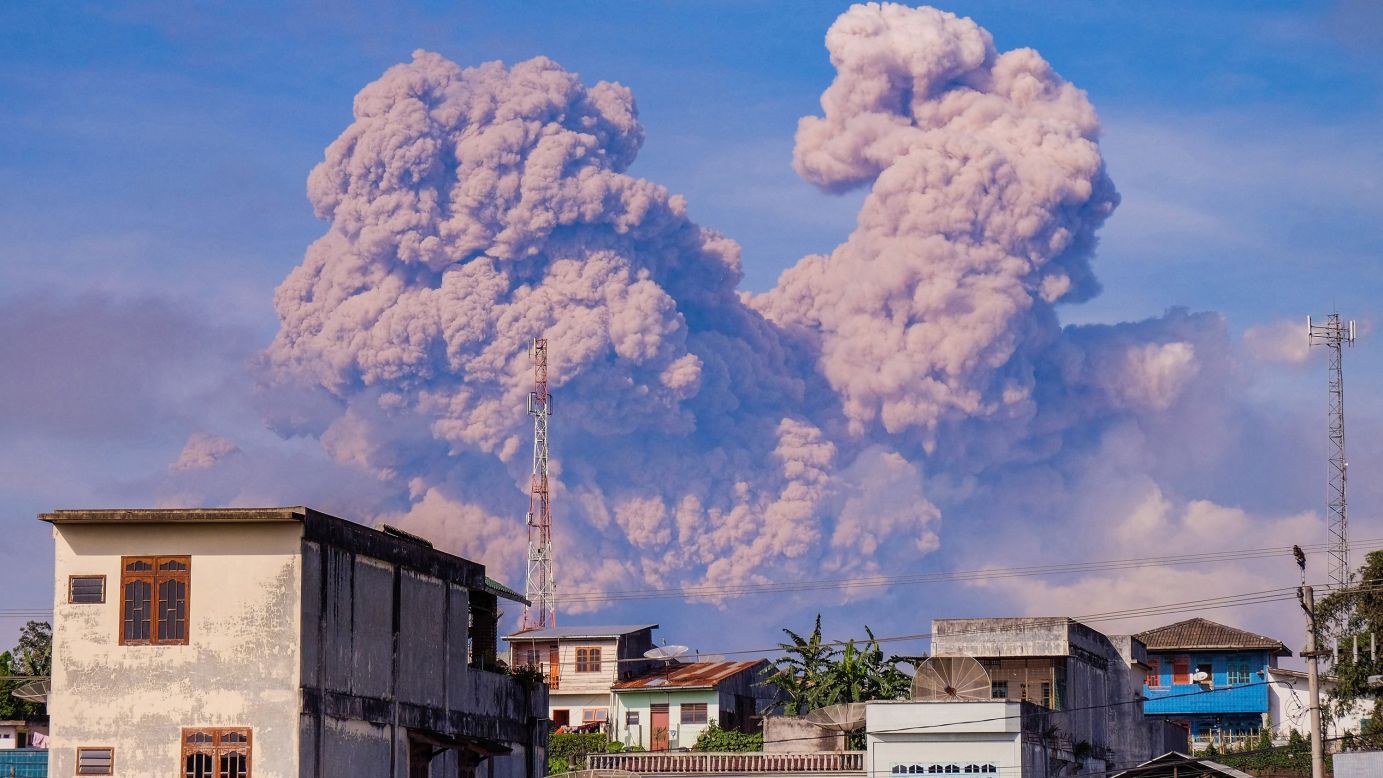 Smoke from the Mount Sinabung volcano is seen from a village on Indonesia's Sumatra island on Sunday, December 14. <a href="http://www.cnn.com/2013/11/20/world/gallery/recently-active-volcanos/index.html" target="_blank">See other recently active volcanoes</a>