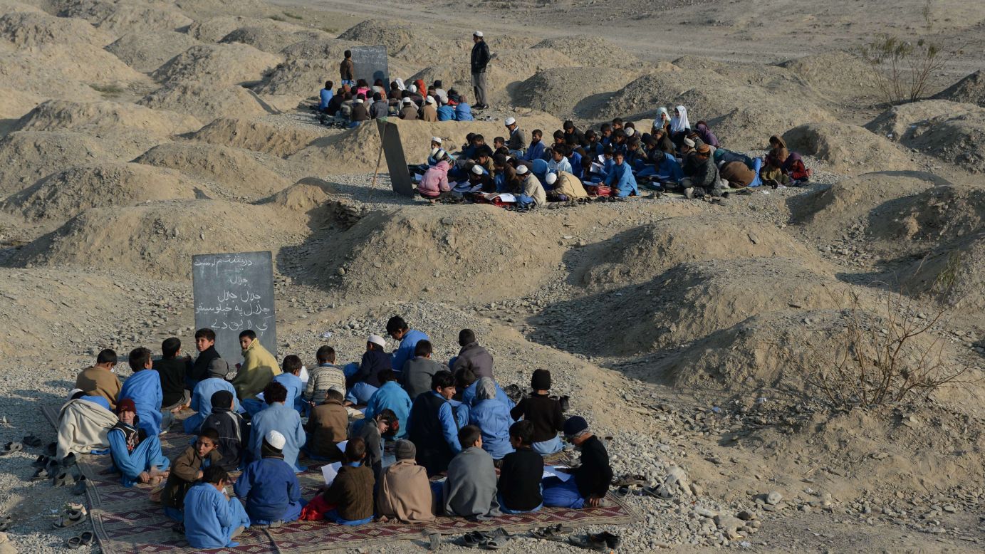 Afghan schoolchildren study at an open-air classroom in eastern Nangarhar province on Thursday, December 18. 