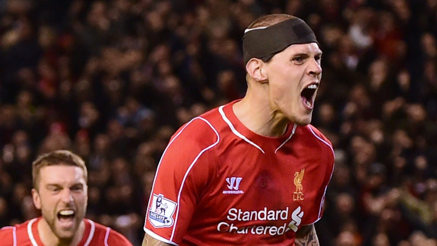 Martin Skrtel celebrates his dramatic late equalizer for Liverpool against Arsenal at Anfield.