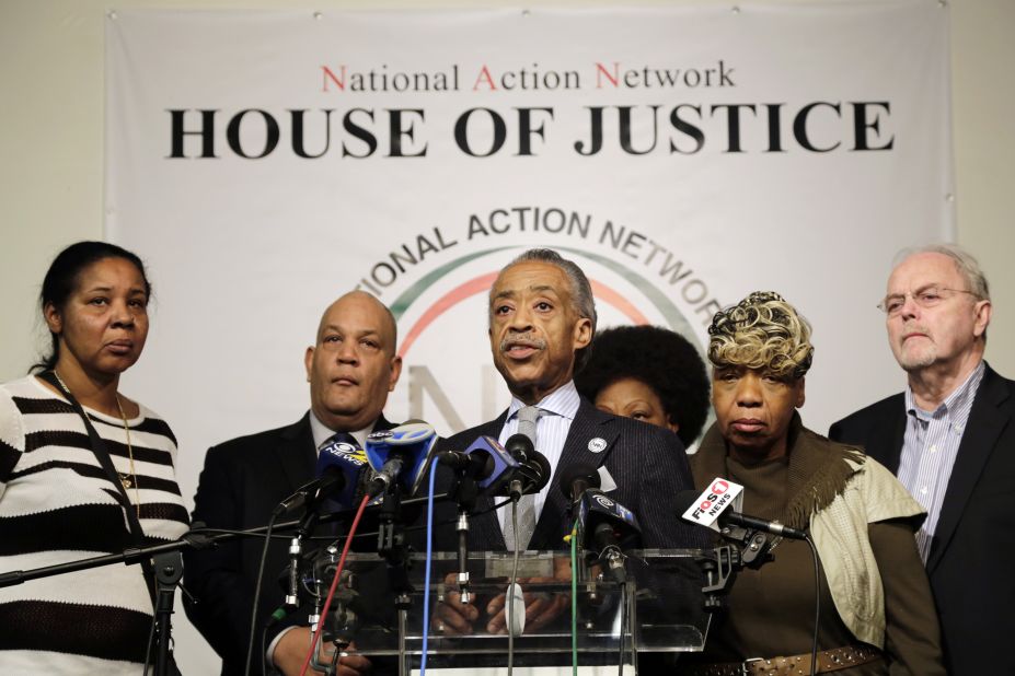 The Rev. Al Sharpton, center, speaks about the killings of the officers during a news conference at the National Action Network headquarters in New York on December 21. Behind him are, from left, Esaw Garner, widow of Eric Garner; attorney Michael Hardy; Gwen Carr, mother of Eric Garner; and attorney Jonathan Moore.