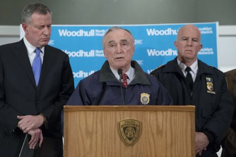 New York Police Department Commissioner Bill Bratton speaks alongside Mayor Bill de Blasio, left, and NYPD's Chief of Department James O'Neill, right, during a news conference at Woodhull Medical Center on December 20. 