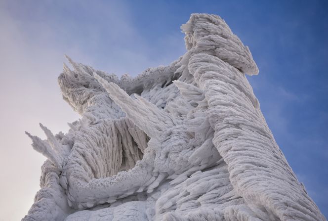  A lookout tower is covered in thick layers of ice. 