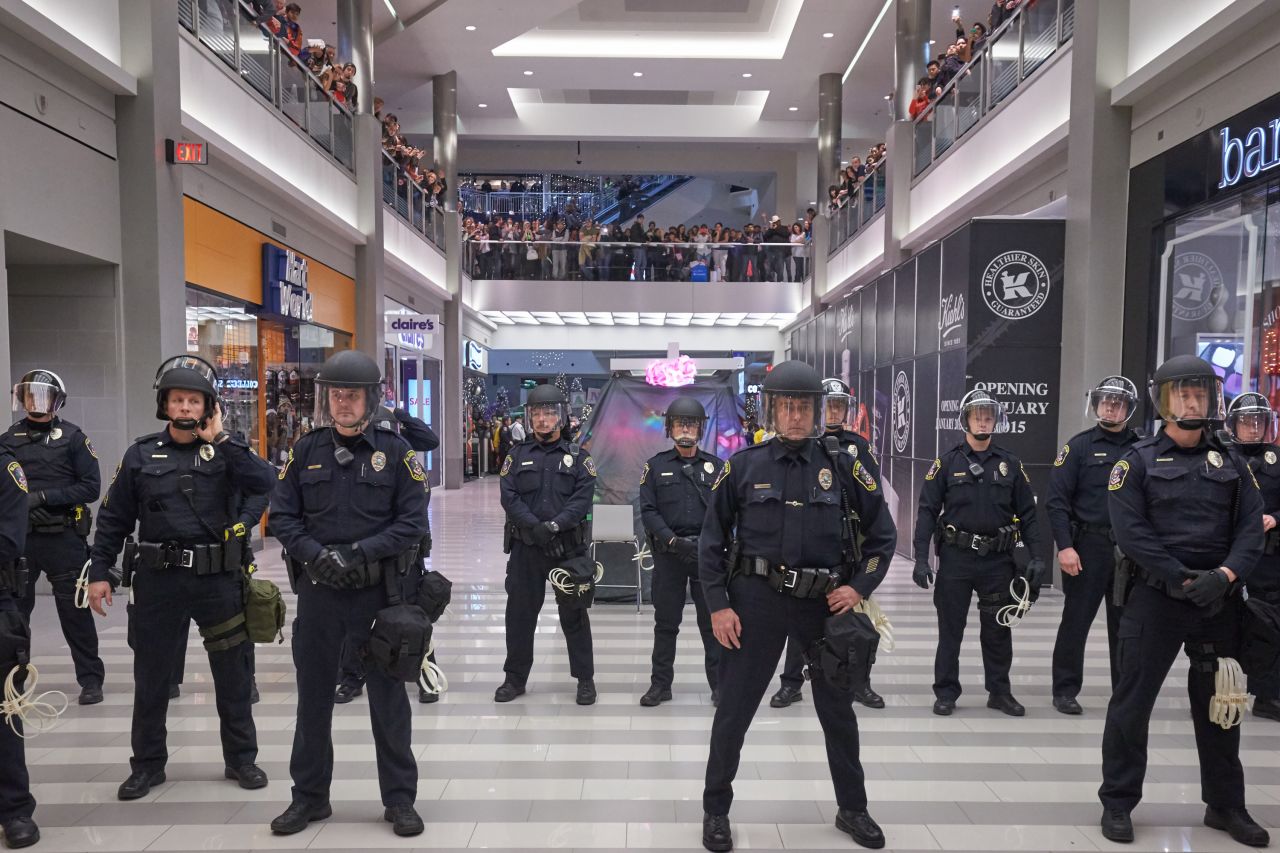 Police line up to move the protesters from out of the mall on December 20 in Bloomington.