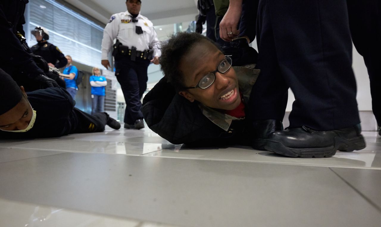 Police arrest a "Black Lives Matter" protester on Saturday, December 20, in Bloomington, Minnesota. Invoking the familiar names of blacks who died at the hands of police, including Eric Garner, Michael Brown and Tamir Rice, thousands have taken part in protests across the country calling for a more aggressive federal response to recent slayings by police.