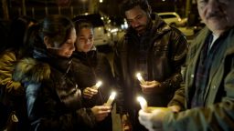 People light candles during a vigil on Sunday, December 21 for two NYPD officers who were ambushed and killed on Saturday.