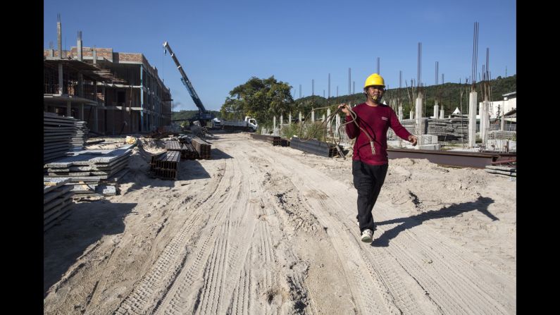 A construction worker walks where buildings are being erected on December 11, 2014, in Phi Phi Village, Ton Sai Bay, Thailand. 