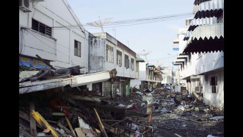A man looks for relatives amid bodies and debris in Banda Aceh on December 28, 2004. 