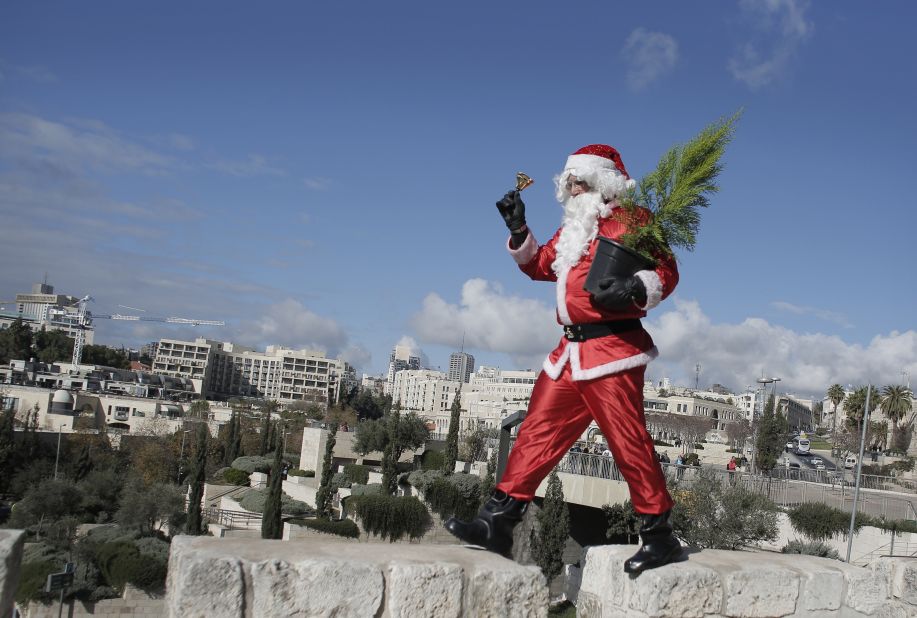 A Palestinian Santa distributes Christmas trees along the wall of Jerusalem's Old City. 