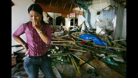 A Thai woman looks at the damage in a hotel in Phuket on December 27, 2004.