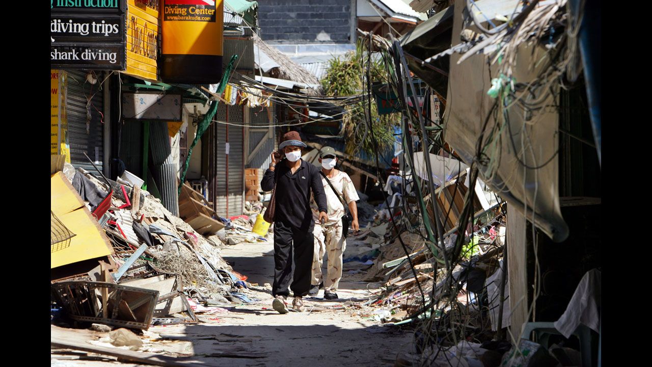 People walk through the streets of tsunami-damaged Phi Phi Village on January 25, 2005, almost one month after the tsunami hit Ton Sai Bay. 