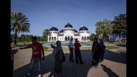 People gather near the Grand Mosque a decade after the tsunami.