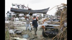 People displaced by the tsunamis, walk amid their ruined neighbourhood on January 4, 2005 in Banda Aceh, Indonesia. Indonesia, the country hardest hit by the Indian Ocean tsunami disaster, has lost over 94,000 people. 