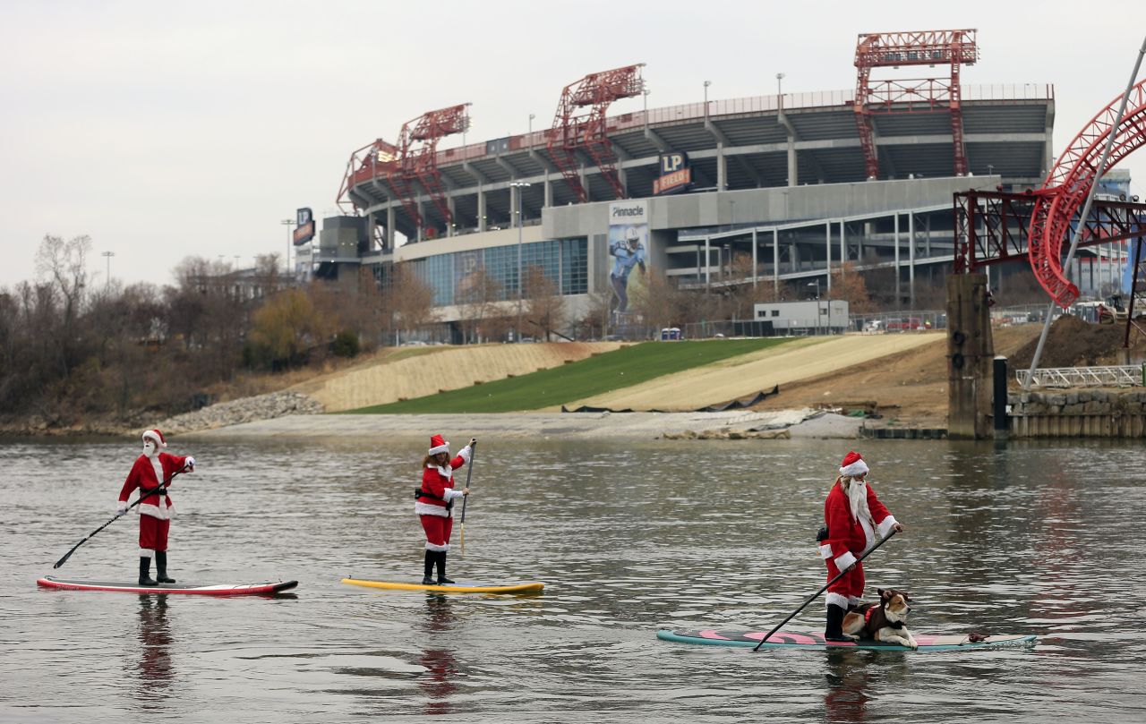 People donning Santa costumes paddle on the Cumberland River in Nashville, Tennessee.