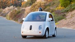 A fully working prototype of Google's self-driving includes cameras and a LIDAR system, but no permanent driver controls like a wheel. 