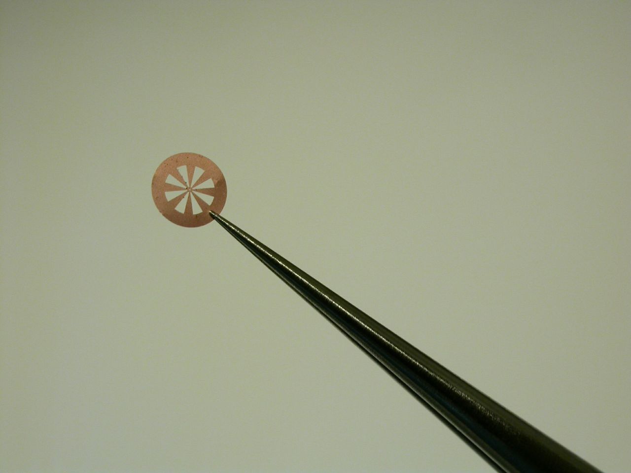 A magnified image of research samples with small holes covered by one-atom-thick graphene. Light can be seen passing through the film with the naked eye.