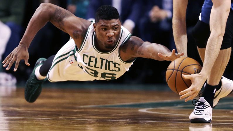 Boston Celtics guard Marcus Smart dives as Minnesota Timberwolves forward Robbie Hummel picks up a loose ball during the second half of the game in Boston on December 19.
