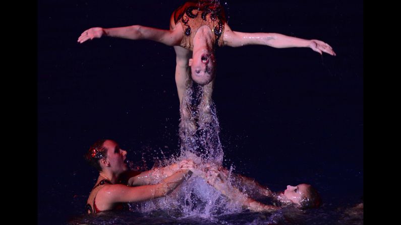 Russian Olympic swimmers compete during the synchronized swimming show at the Olympiysky Sports Complex in Moscow on December 19.