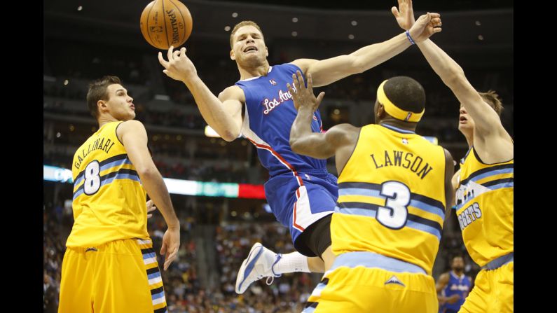 Los Angeles Clippers forward Blake Griffin loses control of the ball as he's fouled by Denver Nuggets guard Ty Lawson on December 19 in Denver.