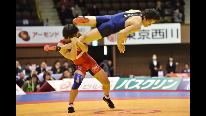 Takafumi Kojima, bottom, and Nobuyoshi Takojima, top, compete in the men's 70kg freestyle final during 2014 Emperor's Cup All Japan Wresting Championship on December 22 in Tokyo.