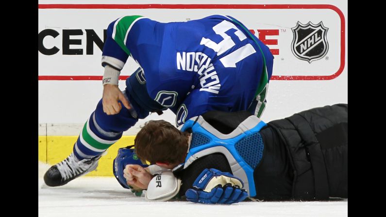 Brad Richardson, top, of the Vancouver Canucks and Curtis McKenzie of the Dallas Stars fight during a game at Rogers Arena on December 17 in Vancouver, Canada.