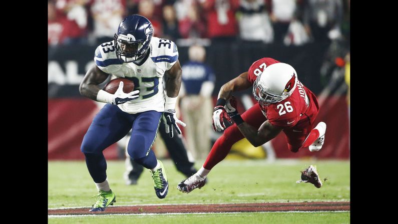 Arizona Cardinal Rashad Johnson runs out of his shoe in a play against Seattle Seahawk Christine Michael on December 21 in Glendale, Arizona.