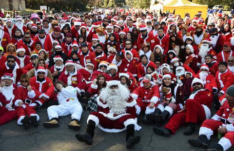 Motorcyclists in Santa outfits take a group photo before embarking on a Christmas "toy run" on their bikes in Tokyo. 