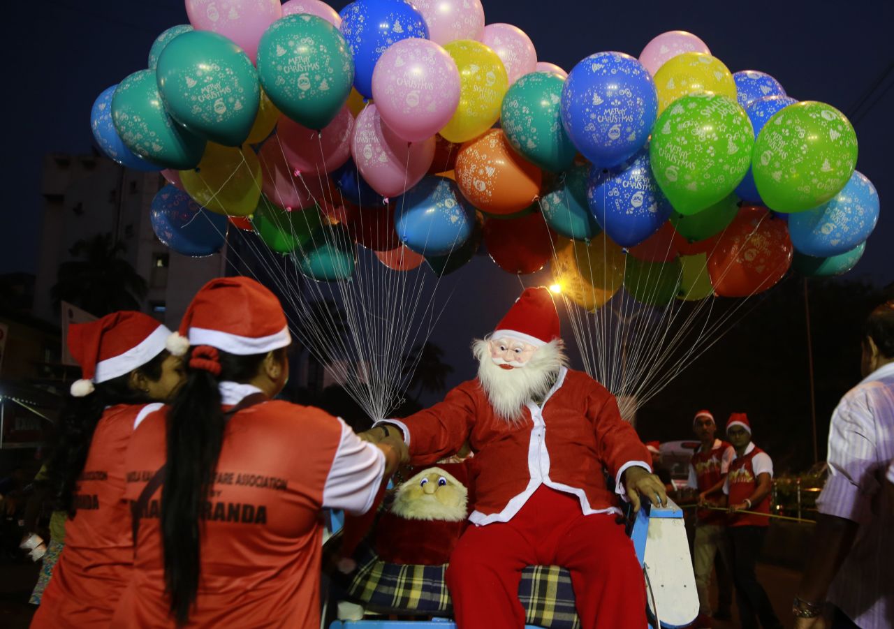 Santa distributes candy during a Christmas carnival in Mumbai, India.