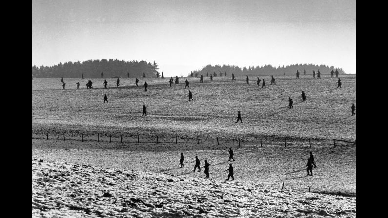 U.S. soldiers scatter across a field during the Battle of the Bulge. The Allies eventually turned back a major German offensive in the Ardennes region of Belgium, Luxembourg and France.