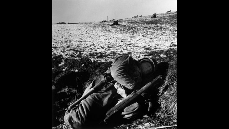 An American soldier rests in his foxhole during the Battle of the Bulge.
