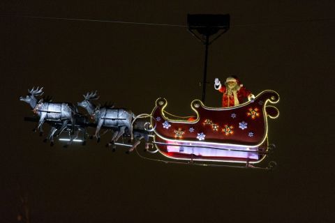 A Santa waves from his sleigh on the Champs-Élysées in Paris.