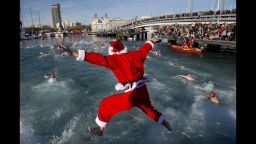 A participant wearing a Santa Clause costume jumps into the water during the105th edition of the Copa Nadal (Christmas Cup) in Barcelona's Port Vell on December 25, 2014. The traditional 200-meter Christmas swimming race gathered around 400 participants on Barcelona's old harbour.  AFP PHOTO / JOSEP LAGO        (Photo credit should read JOSEP LAGO/AFP/Getty Images)