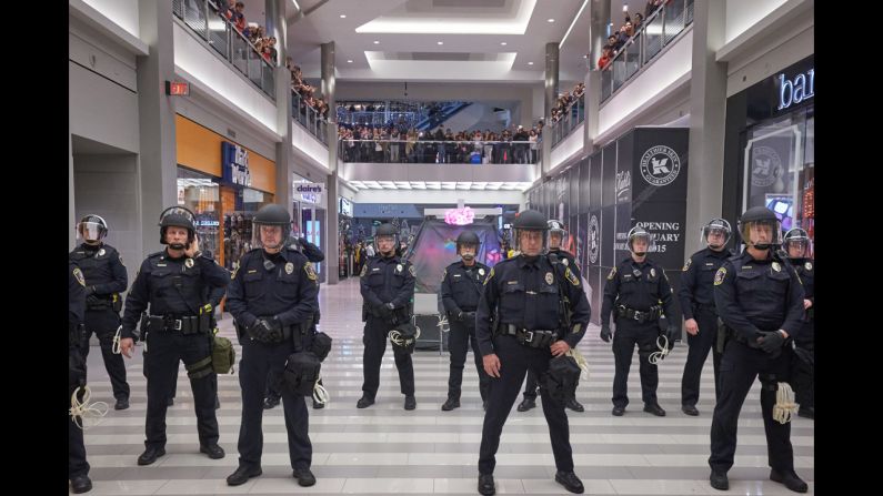 Police move hundreds of "Black Lives Matter" protesters out of the Mall of America after they disrupted holiday shoppers on Saturday, December 20, in Bloomington, Minnesota. 