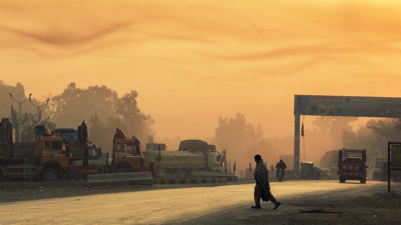A man crosses the street near Forward Operating Base Fenty at sunrise in Afghanistan on Friday, December 19.