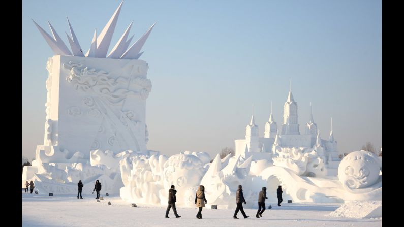 Workers put the final touches on a sculpture at the 27th Harbin Sun Island International Snow Sculpture Art Expo on Saturday, December 20, in Harbin, China. 