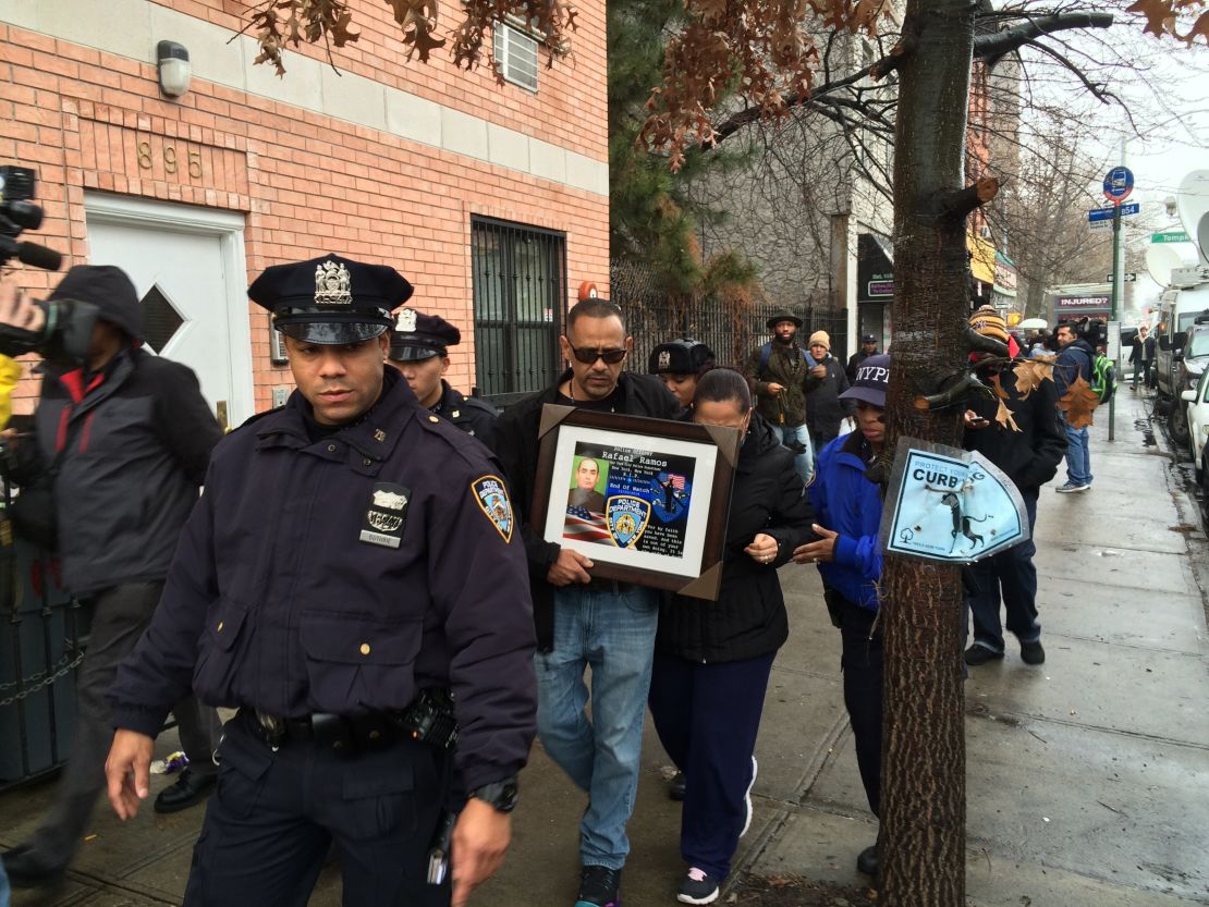 Visitors pay respects to two slain police officers this week at a memorial in New York's Bedford-Stuyvesant neighborhood.