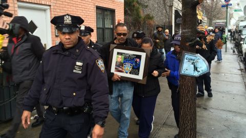 Visitors pay respects to two slain police officers this week at a memorial in New York's Bedford-Stuyvesant neighborhood.