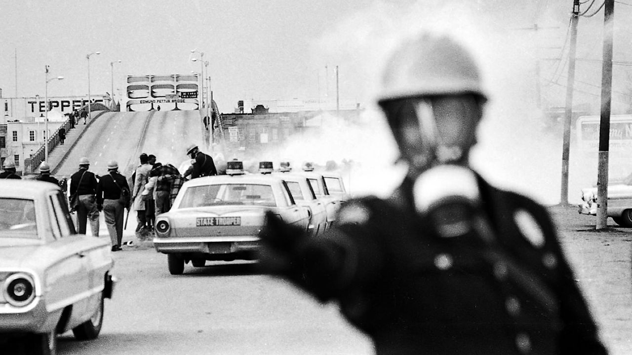 About 600 people began a 50-mile march from Selma to the Alabama state capitol in Montgomery on March 7, 1965. They intended to protest discriminatory practices that prevented black people from voting. But as the marchers descended to the foot of the Edmund Pettus Bridge, state troopers used brutal force and tear gas to push them back.
