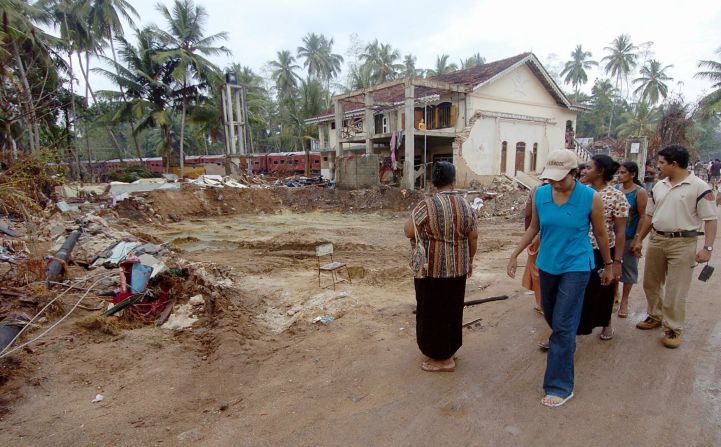 People walk among the rubble of the tsunami in Hambantota, Sri Lanka in January 2005. The Indian Ocean tsunami struck on 26 December 2004, causing massive destruction along coastal areas of 14 countries, including Thailand, India, Sri Lanka, Indonesia and Malaysia.