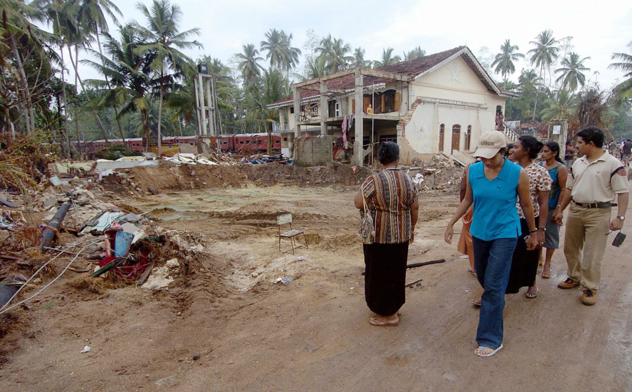 People walk among the rubble of the tsunami in Hambantota, Sri Lanka in January 2005. The Indian Ocean tsunami struck on 26 December 2004, causing massive destruction along coastal areas of 14 countries, including Thailand, India, Sri Lanka, Indonesia and Malaysia.