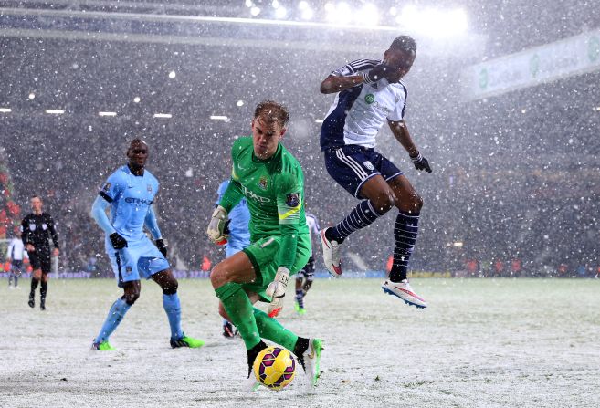 Heavy snow hit the WBA - Man City clash at the Hawthorns but it did not stop the visitors winning 3-1 to keep up pursuit of Chelsea.