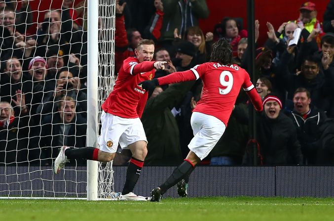 Wayne Rooney is congratulated by Radamel Falcao after scoring during Manchester United's 3-1 win over Newcastle to stay third.